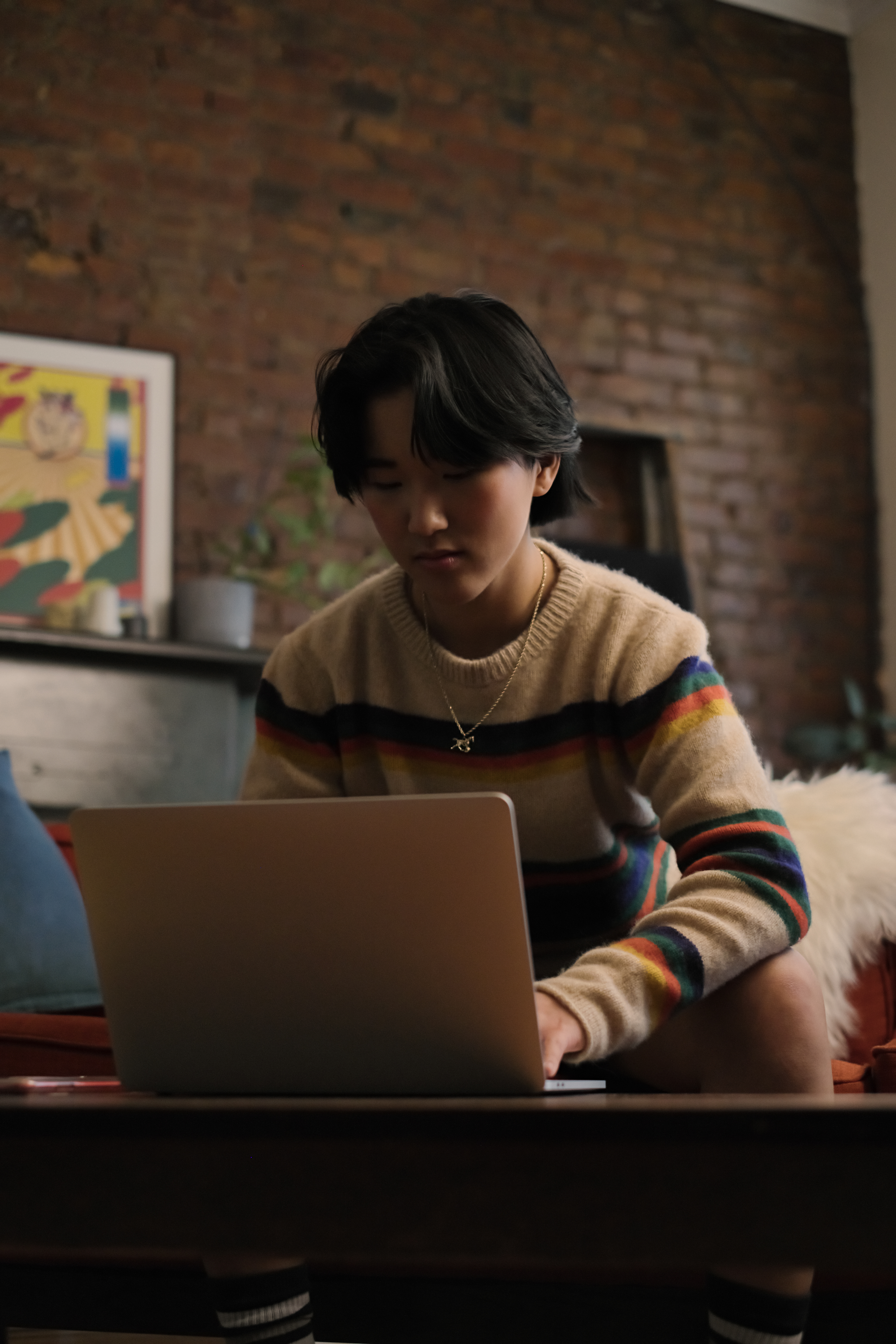 A non-binary person looking at a cellphone (1) photograph of a library